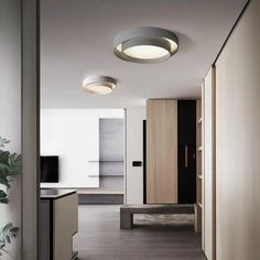 an empty hallway leading to a kitchen and living room with wood paneling on the walls