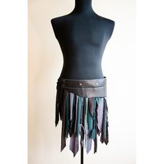 a mannequin wearing a leather belt with fringes