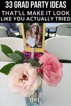 a vase filled with flowers on top of a white table next to a photo frame