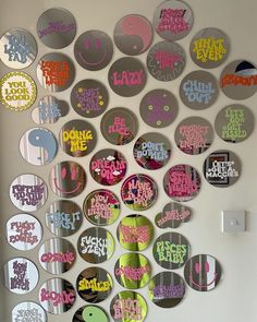 there are many circular mirrors on the wall with different colors and designs around them that say don't be lazy