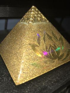 a golden triangle shaped object sitting on top of a table