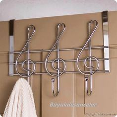 a coat rack with three hooks and two coats hanging on it