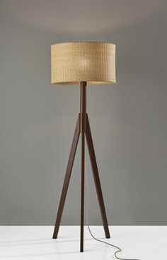 Truly a mix of design and functionality that doesnt compromise on style, this 59 inc tripod floor lamp with brown drum shade will be a great addition to your space. The lamp shade itself has a drum shape and is made of wicker rattan, which makes it a perfect choice. A sturdy three leg base gives this tripod style floor lamp a designer style that leans towards modern and industrial for a unique and stylish look. The light that this lamp throws is soft and warm to elevate the look of most any space in your home. The perfect lamp to create just the right natural and soothing light in your space. 59 inc H x 18.5 inc W x 18.5 inc D. HomeRoots 59-in Walnut Tripod Floor Lamp | 4000372867 Walnut Wood Floors, Affordable Lighting, Natural Wood Flooring, Tripod Floor Lamp, Wood Floor Lamp, Tripod Floor Lamps, Luz Natural, Tripod Lamp, Lamp Decor