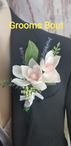 a close up of a suit with flowers on it and the words grooms bout