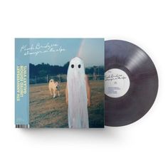 an album cover with a ghost standing next to a dog