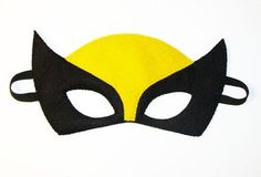 a yellow and black cat mask on a white background