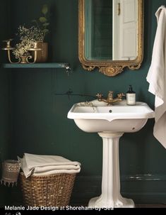 a white sink sitting under a bathroom mirror next to a basket filled with toilet paper