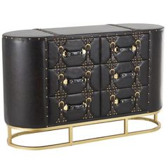 a black and gold cabinet with lots of studding on the doors, drawers and handles