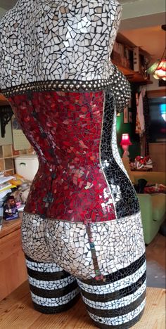 a woman's corset made out of mosaic tiles