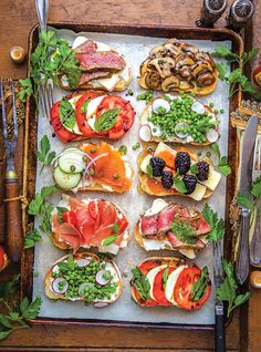 a tray filled with lots of different types of food on top of a wooden table