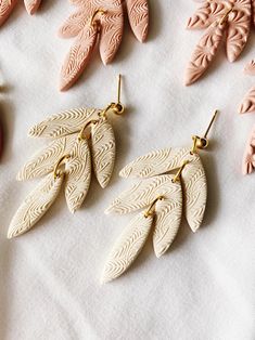 several different types of earrings sitting on top of a table