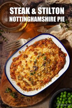 the cover of steak and stilton nottingham shire pie with peas on the side