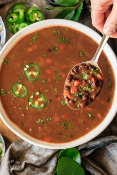 a spoonful of chili soup with beans and jalapenos