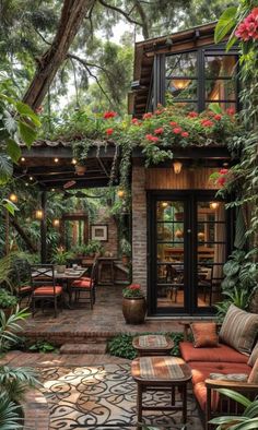 an outdoor patio with lots of plants and furniture