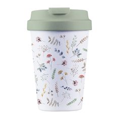 a coffee cup with a green lid and floral designs on it