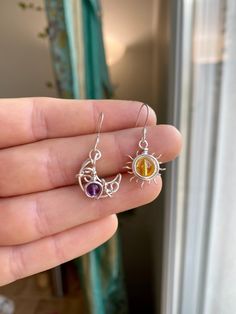 🌙PLEASE READ DETAILS BELOW! 🌙 Mini Sun and Moon Earrings These mini sun and moon earrings are a perfect way to bring a beautiful energy to your life! The design was hand crafted from sterling silver wire and features purple Amethyst and yellow Citrine crystals. I've coated the wire design with a tarnish resistant lacquer to help protect the bright silver finish. Comes with .925 sterling silver earring hooks.  🌟🚫Standard shipping does NOT include a tracking number!--Upgrades are available at Moon Earrings Silver, Sun And Moon Earrings, Bijoux Fil Aluminium, Earrings Wire, Citrine Crystal, Moon Jewelry, Wrapped Jewelry, Moon Earrings, Sun And Moon