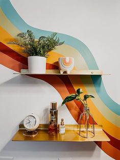 a shelf with some plants on it and a clock in front of the wall behind it