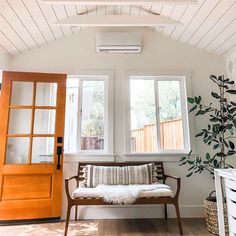 a living room filled with furniture and a wooden door