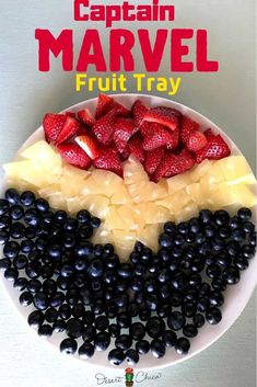 a white plate topped with fruit next to blueberries and strawberries on top of each other