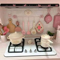 a doll house kitchen with pots and pans on the stove top, cooking utensils