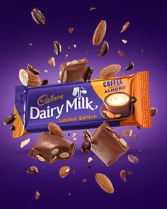 an advertisement for dairy milk with chocolate and almonds falling into the air on a purple background