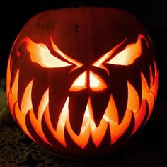 a carved pumpkin with an evil face on it