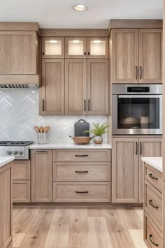 a kitchen with wooden cabinets and white counter tops, an oven and microwave in the center