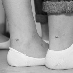 two people with small tattoos on their legs, one has the words we are in cursive writing