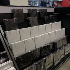 there are many black and white bags on the shelf