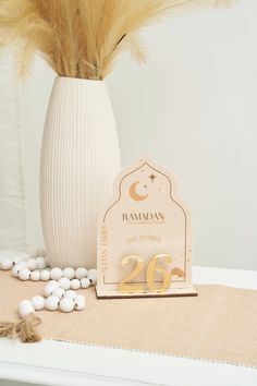 a white vase filled with lots of candy next to a sign that says raman