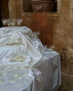 a table topped with lots of wine glasses