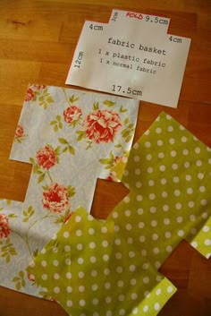 three pieces of fabric sitting on top of a wooden table