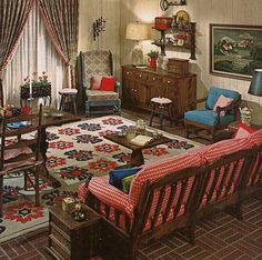 a living room filled with furniture next to a window covered in red and white curtains