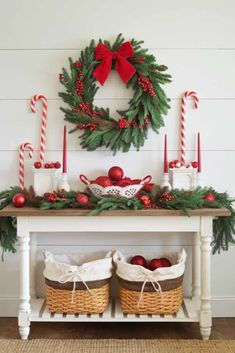 a christmas mantle with wreath, candy canes and ornaments