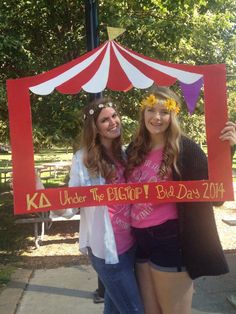 two girls holding up a sign that says under the big top b - day 2014