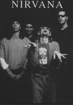 the nirvana band standing in front of a black background