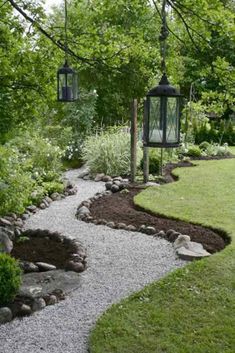 a garden with gravel, rocks and lights