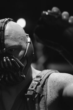 black and white photograph of a man wearing a batman mask