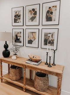 a wooden table with pictures on the wall