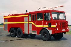 a red fire truck is parked on the street