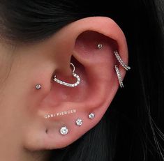 an ear with three different piercings on it