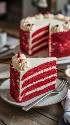 a slice of red velvet cake with white frosting