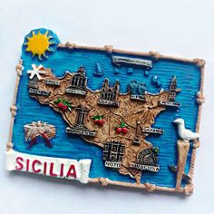 a small wooden magnet with a map of the state of scillia on it