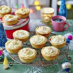 there are many small cupcakes on the wire rack next to each other,