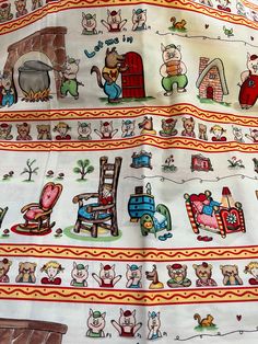 an image of a very colorful fabric with animals and houses on it's sides