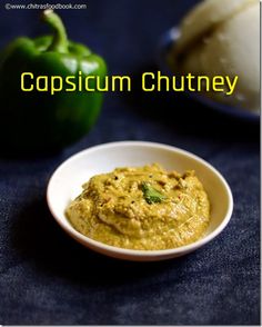 a white bowl filled with guacamole next to an green pepper and bell pepper