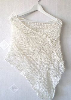 a white crop top hanging on a hanger