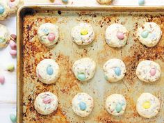 a baking sheet filled with easter cookies and candy candies on top of a table