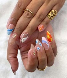 a woman's hands with different nail designs on them