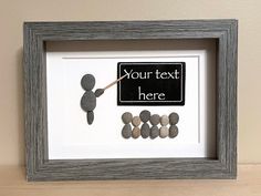 a frame with rocks and a sign that says your text here